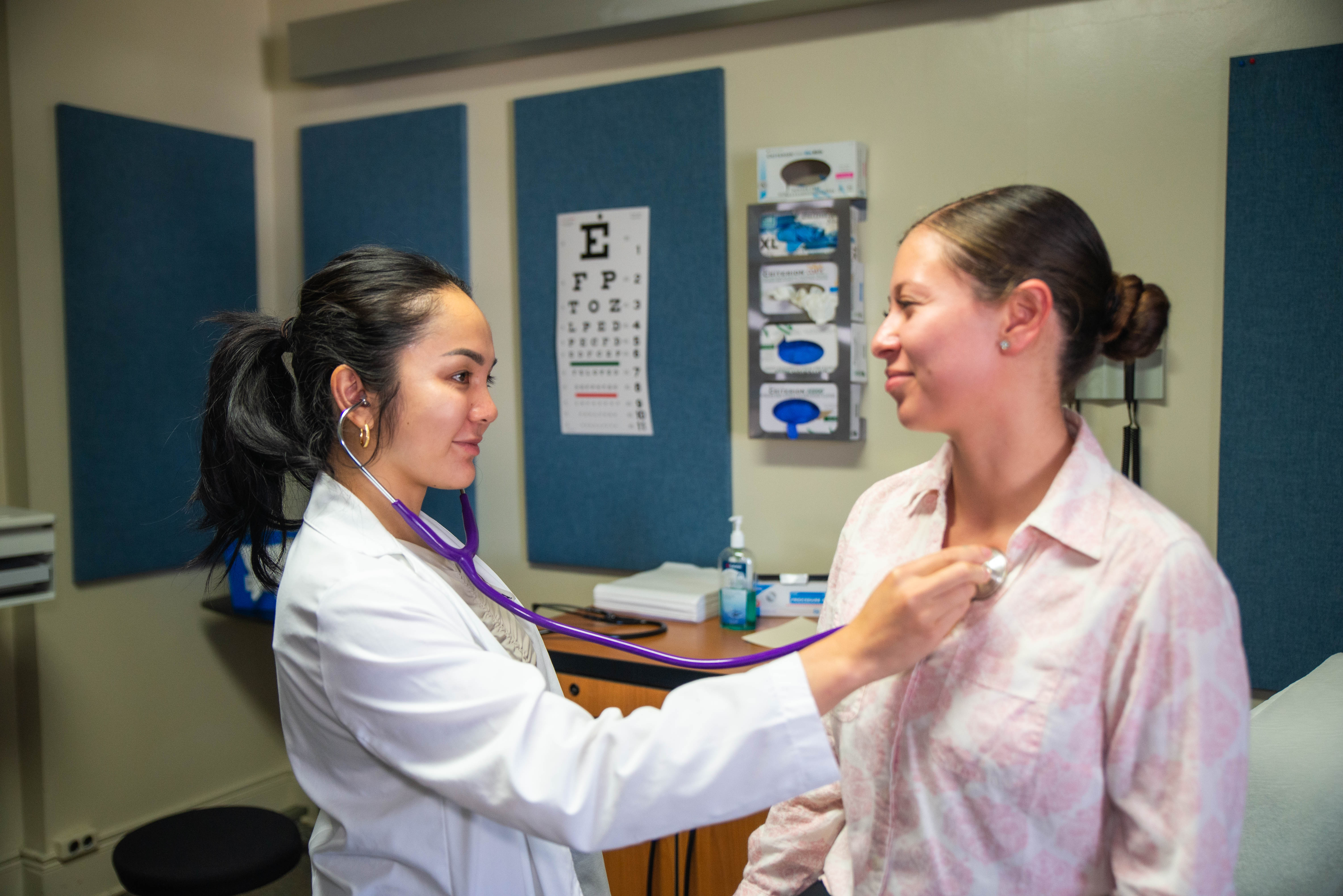 Physician Assistant listens to the heartbeat of their patient. 