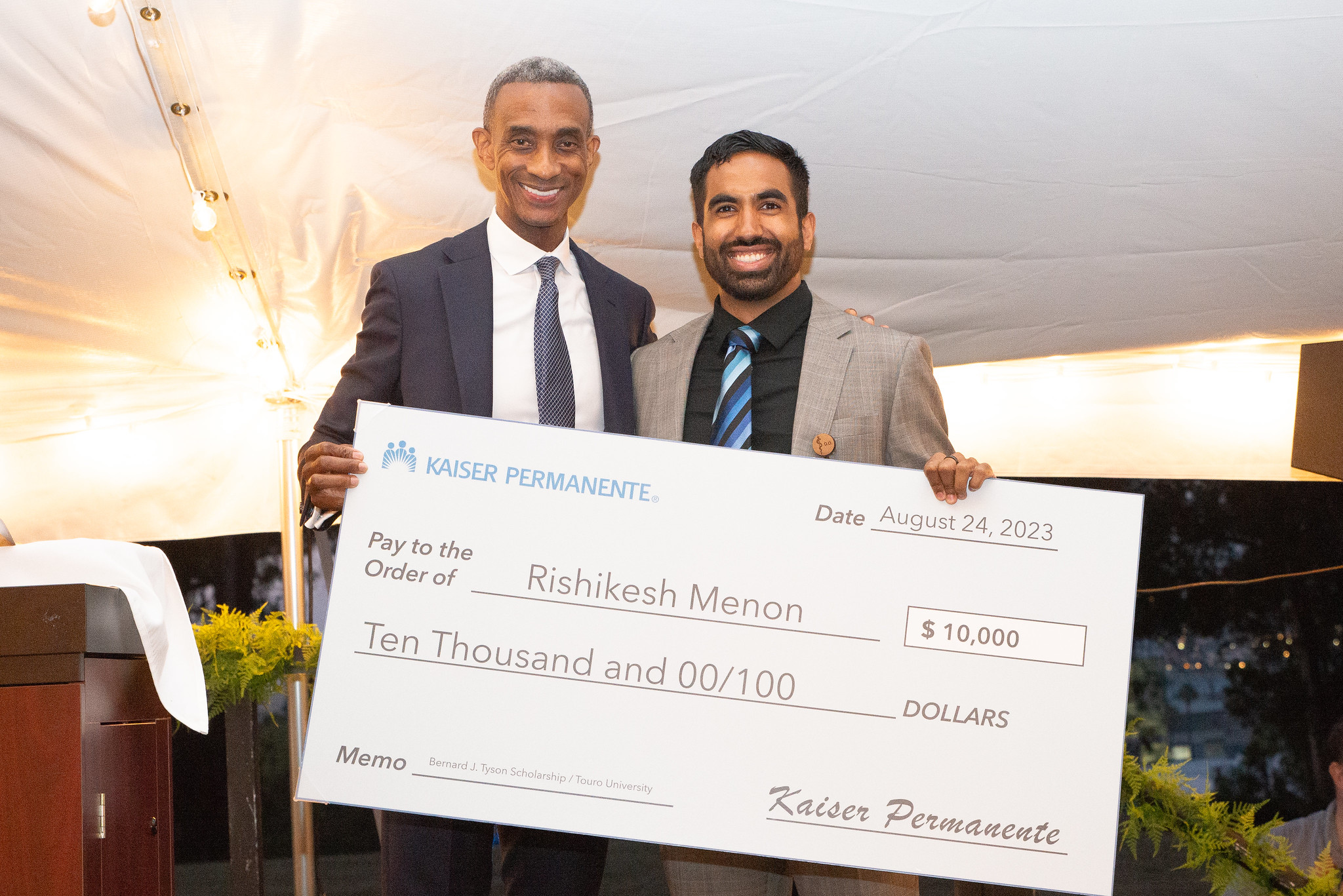 Darryl Curry standing next to Rishikesh Menon holding a giant check for $10,000