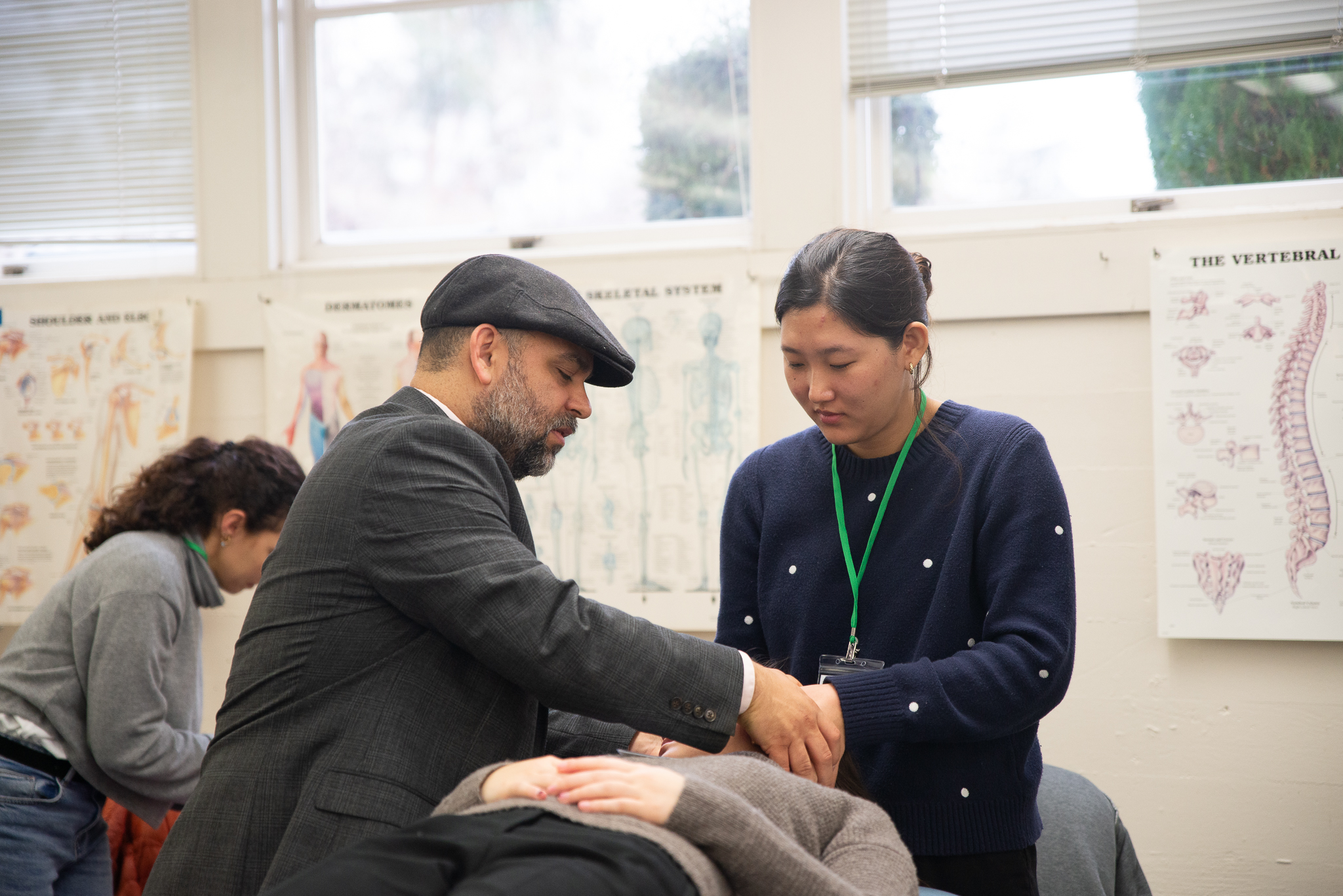  Associate Professor Dr. Victor Nuno demonstrates Osteopathic Manipulative Medicine to a symposium attendee