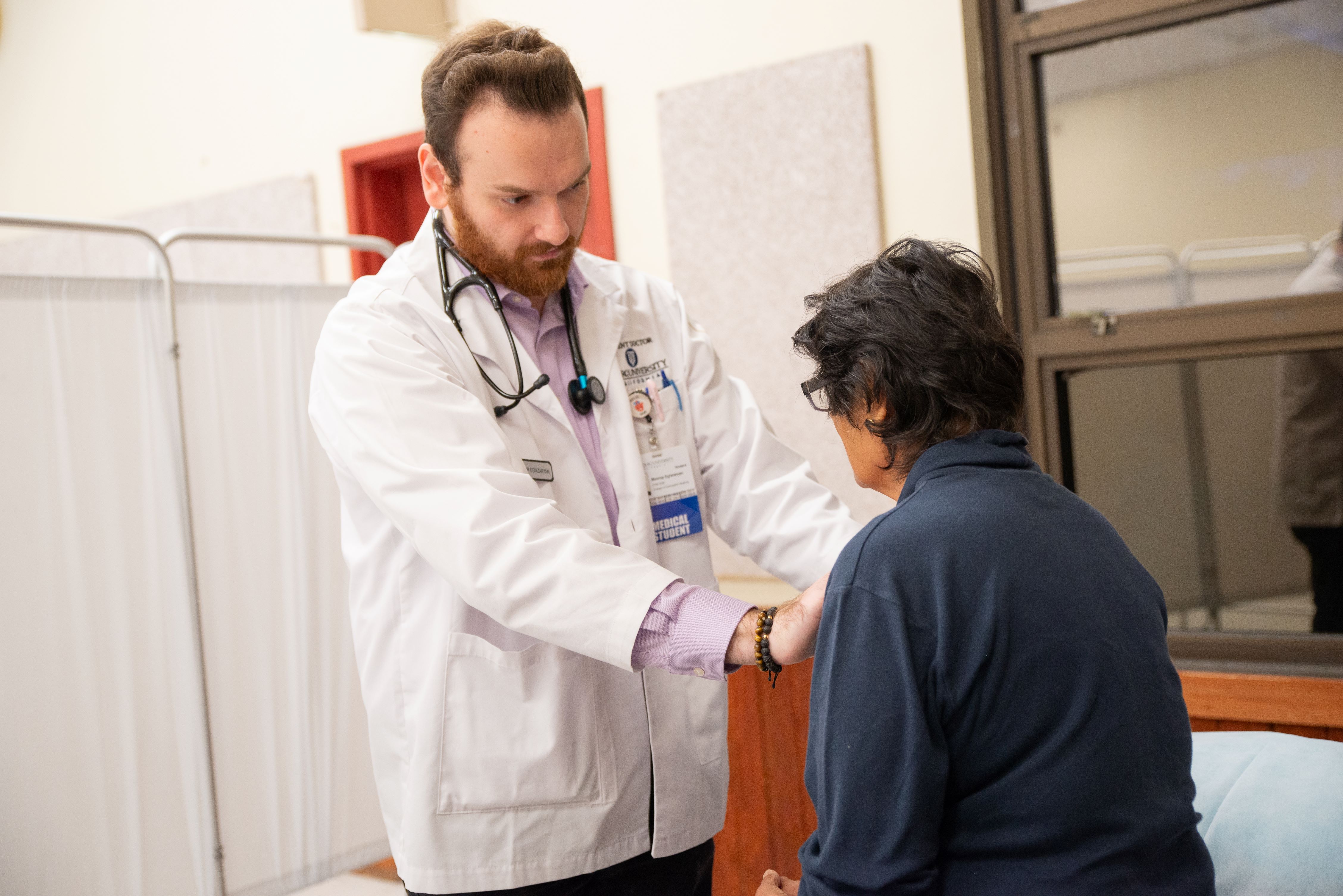 Student clinician helping a patient with a health screening