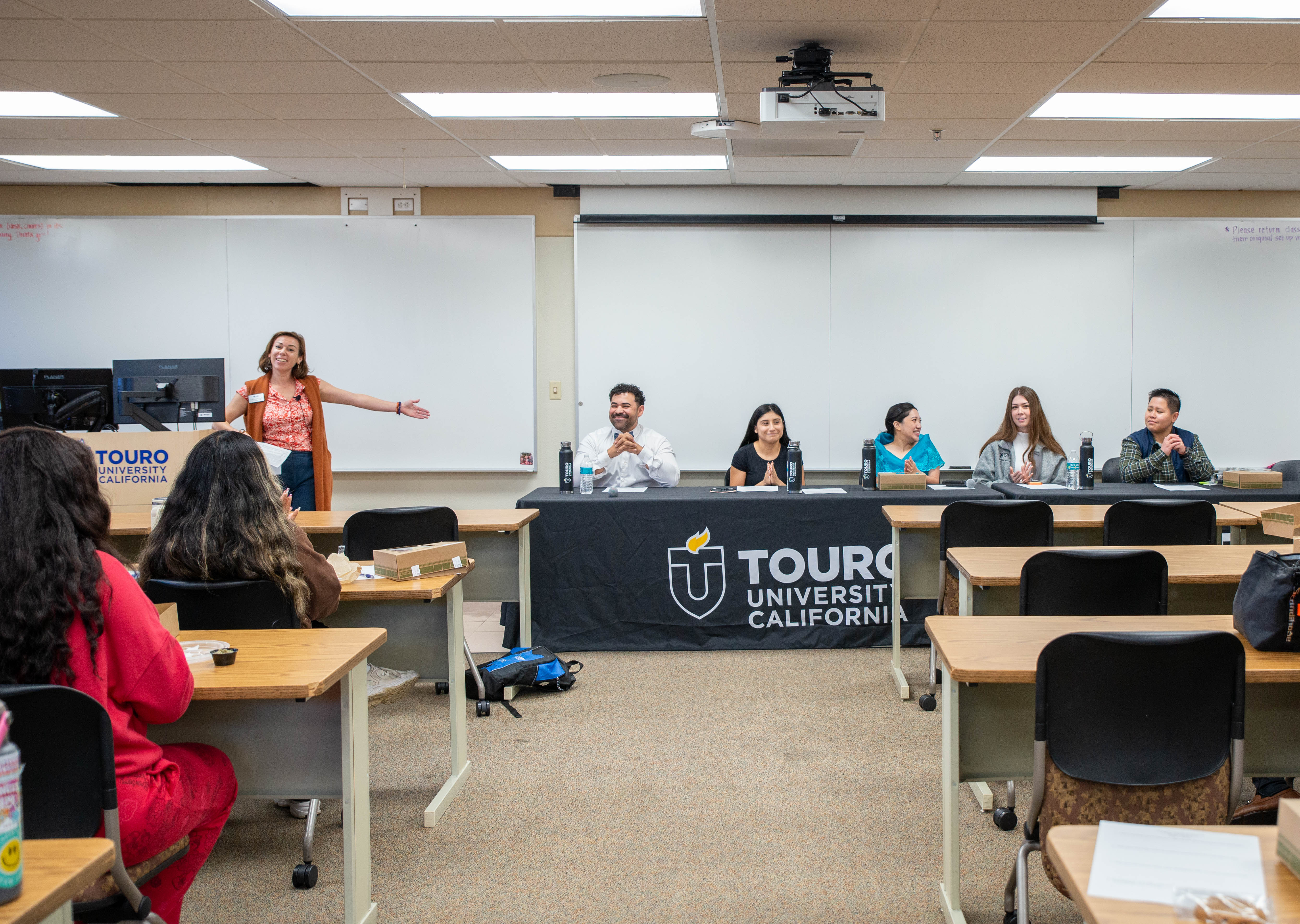 A photo shows Yvette Elizabeth Carrillo, Director of Student Activities, as she introduces students taking part in the “Celebrating our Collective Voices in Health Care: Stories from our Latino and Filipino Communities” panel discussion on campus, Oct. 28, 2025.