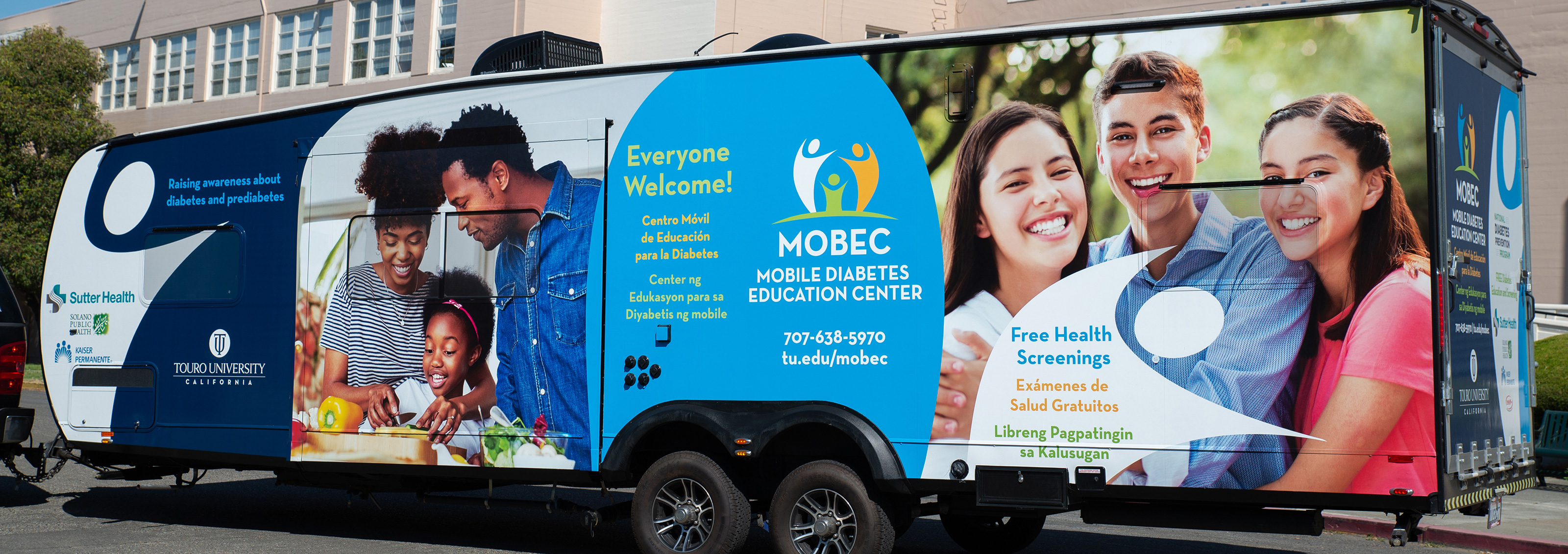 bus with mobec logo and images of two women and a man, and a man woman and child