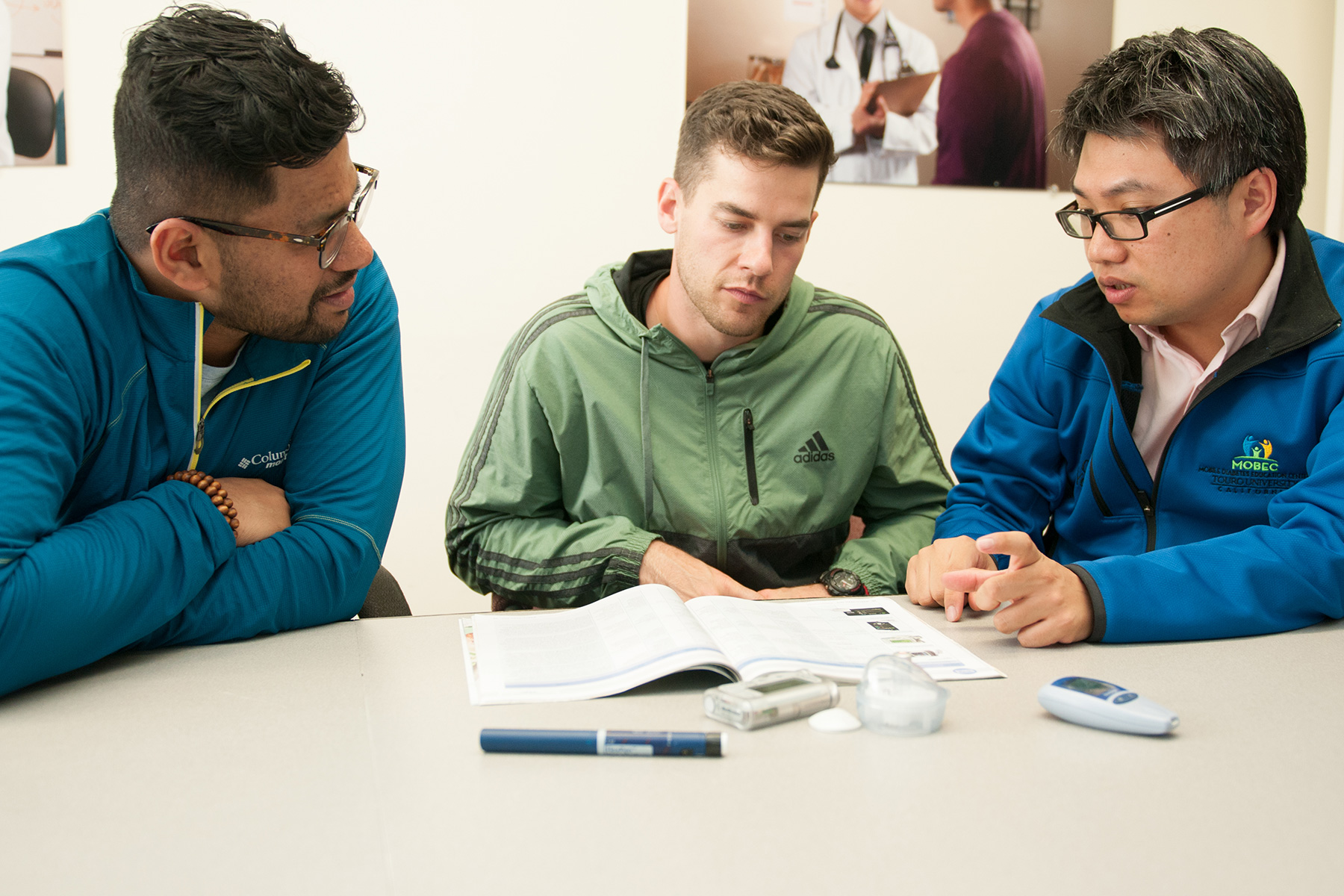 three men sitting at a table