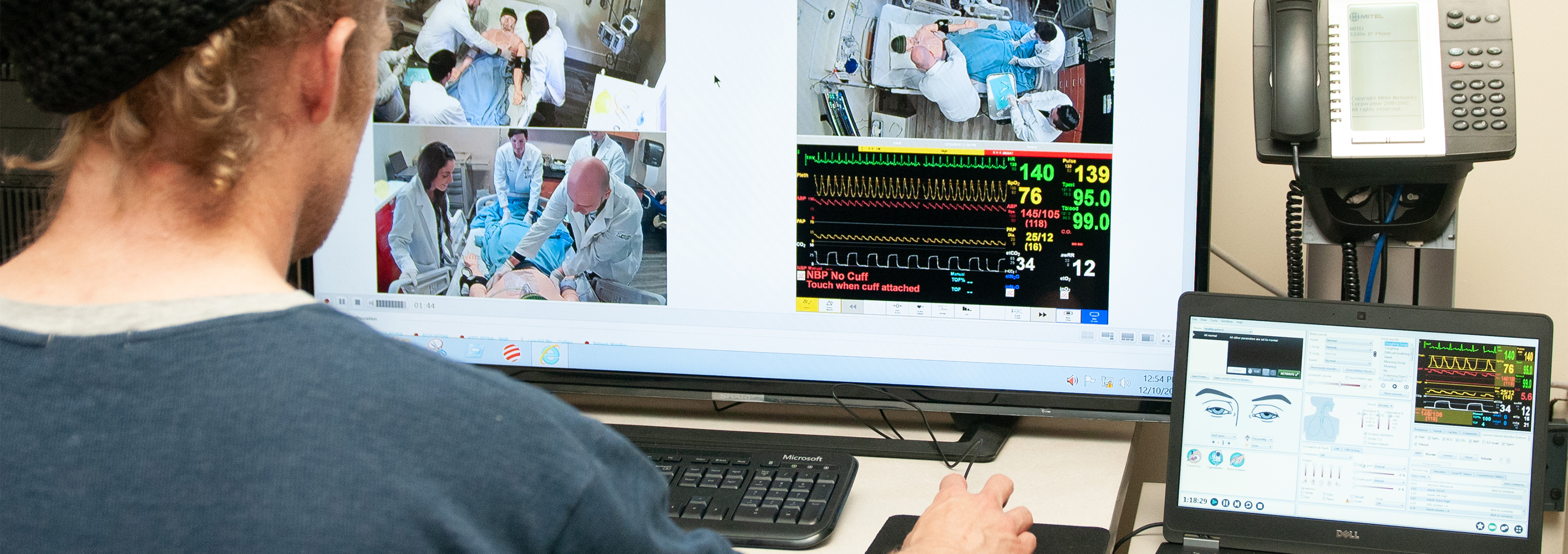 man sitting at a computer viewing an operation