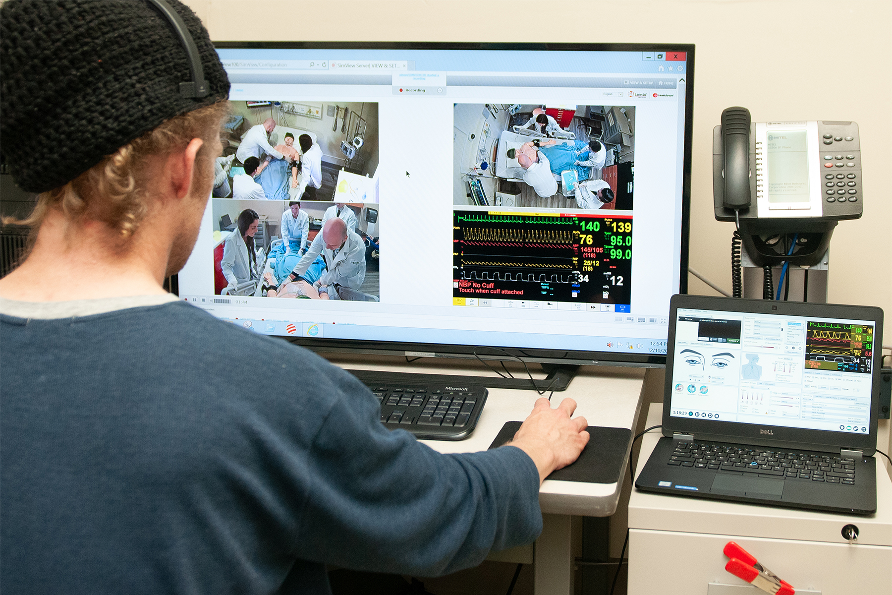 man sitting at a computer viewing an operation