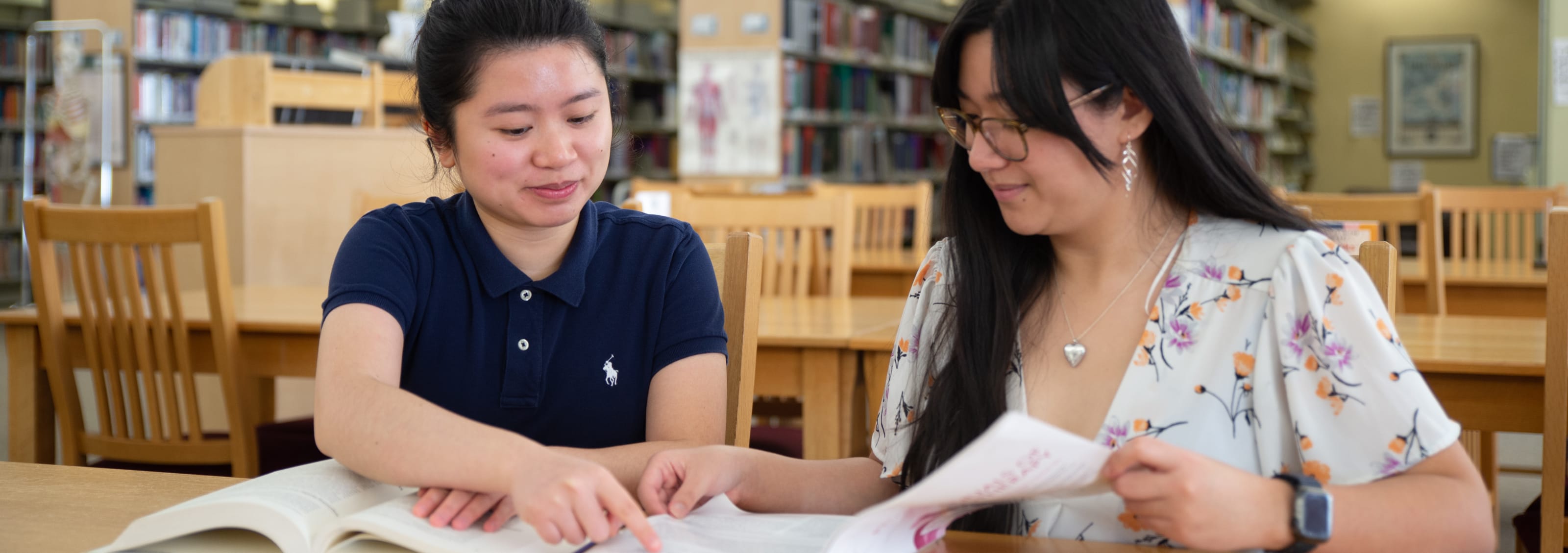 two students working together in library