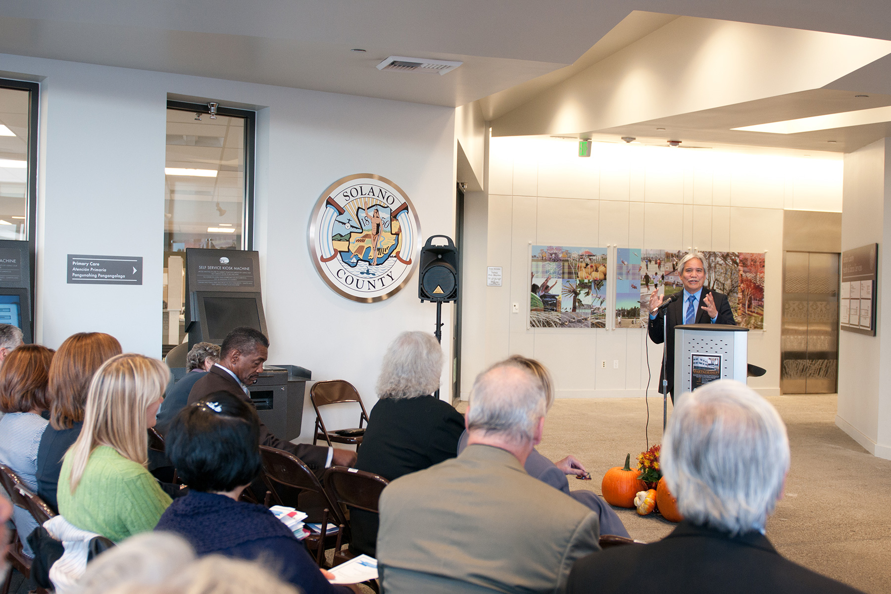 Man standing at a podium talking to a group of people