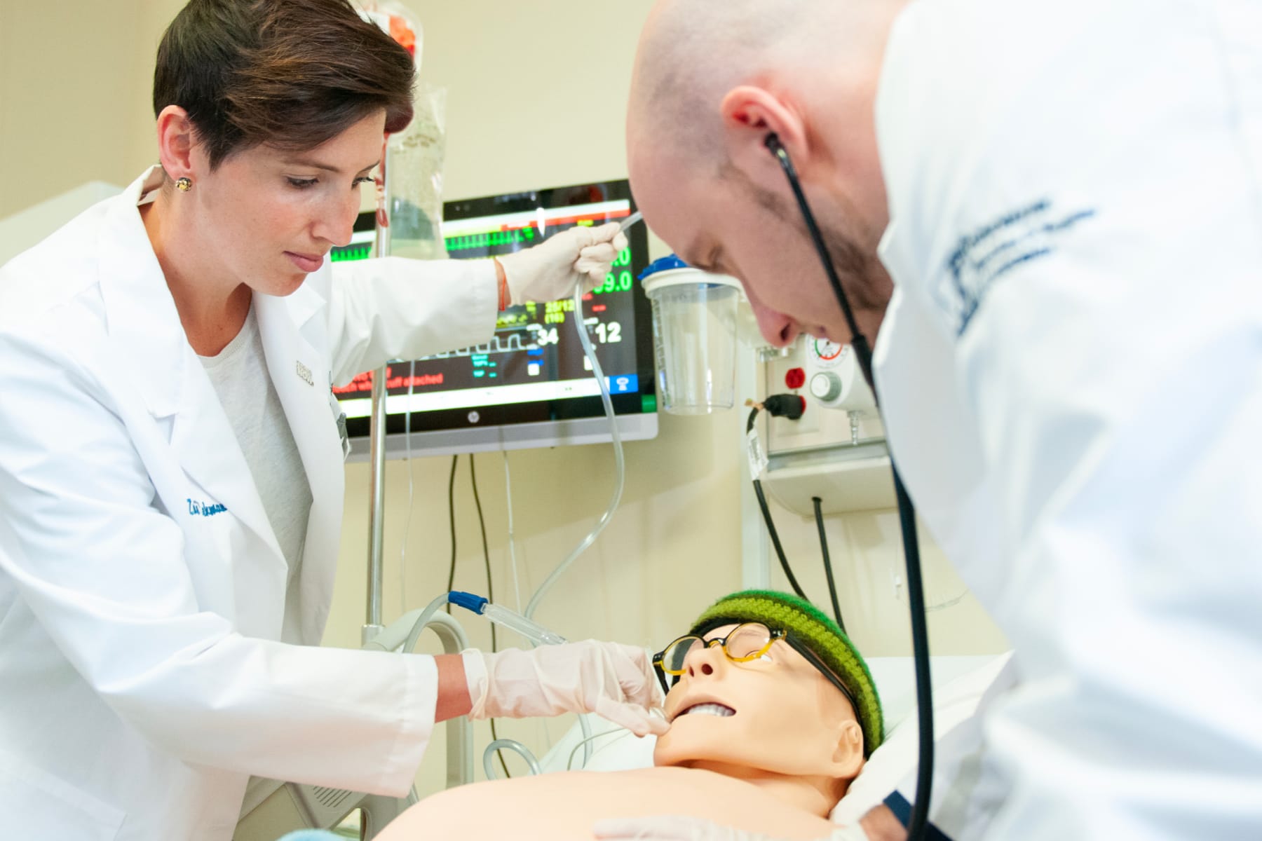 two medical students with a simulated patient