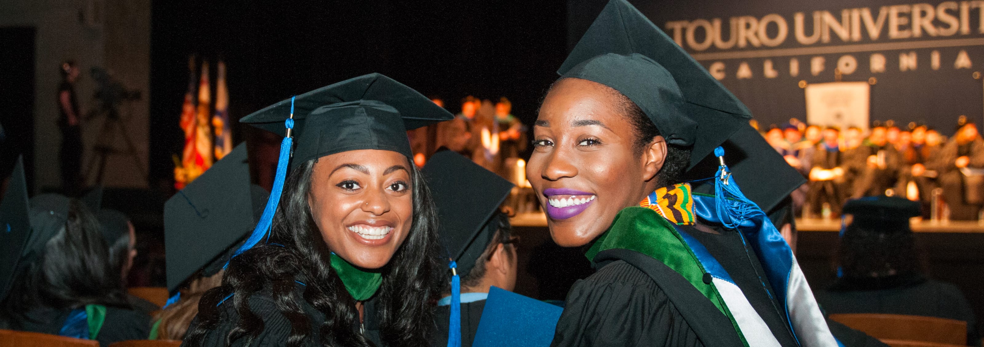 2 smiling graduates