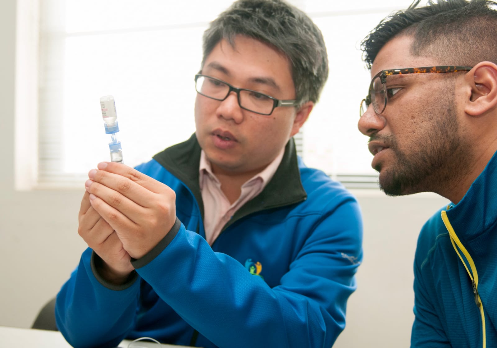 two students with a vial of insulin