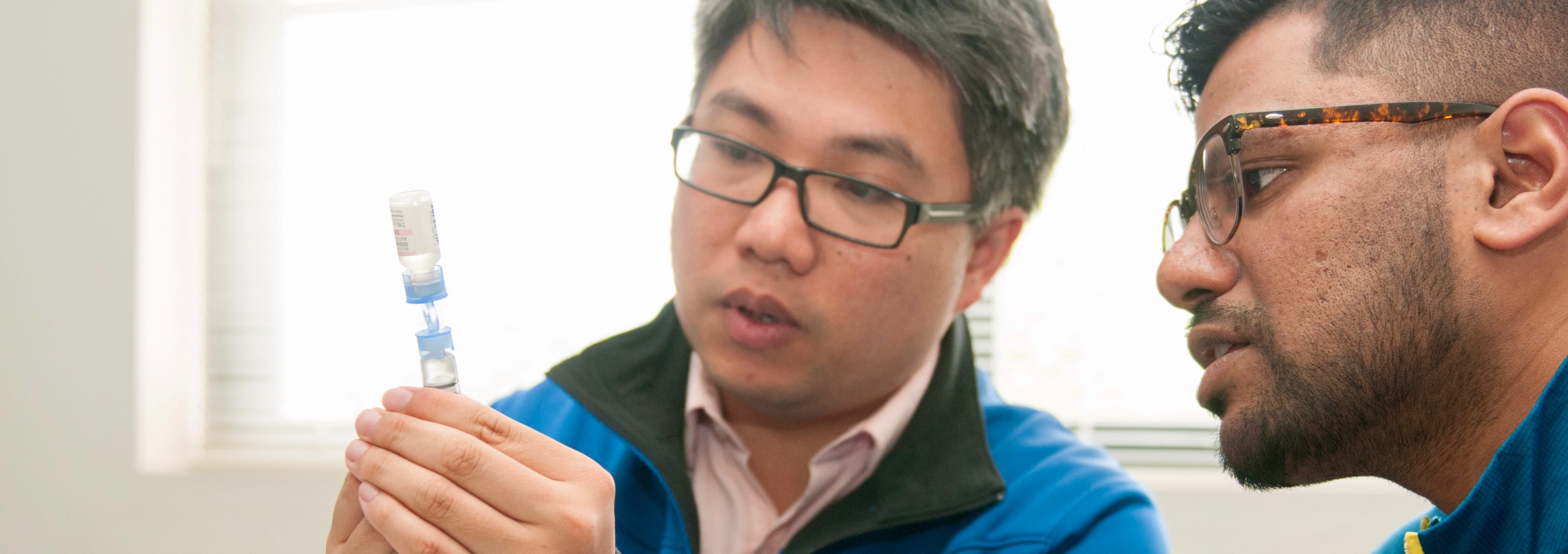 two students with a vial of insulin