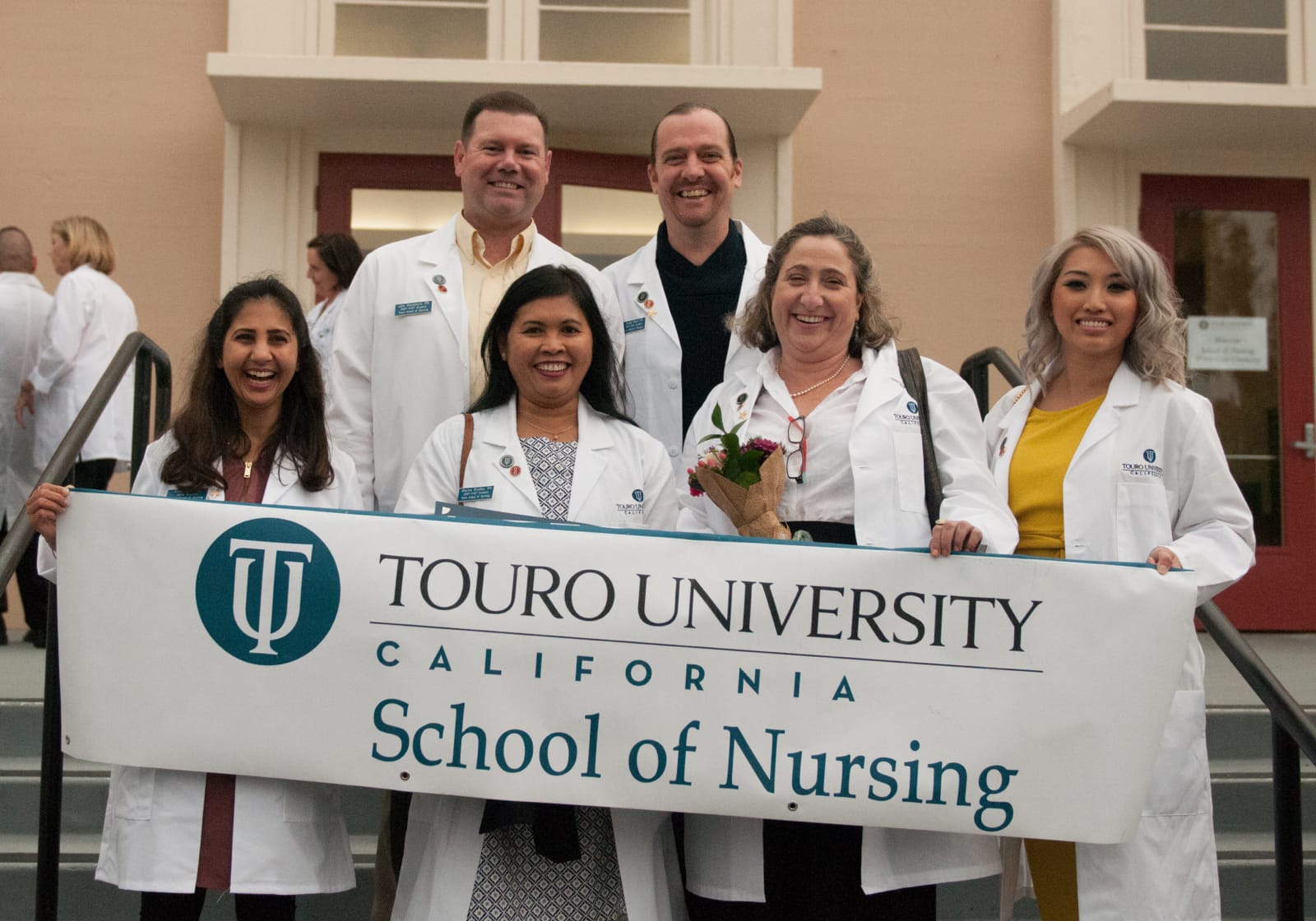 TUC nursing students in white coats posing