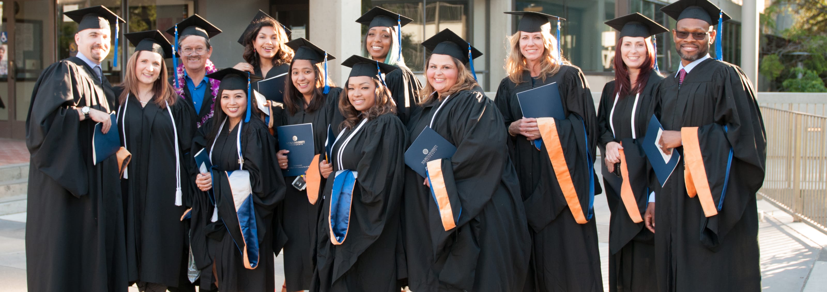 group shot of TUC nursing graduates in caps and gowns