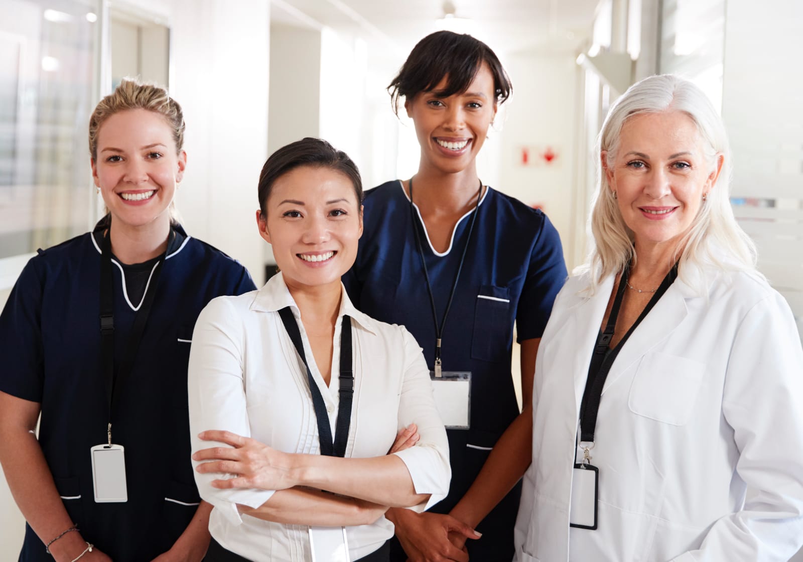 four nurses of varying ages smiling