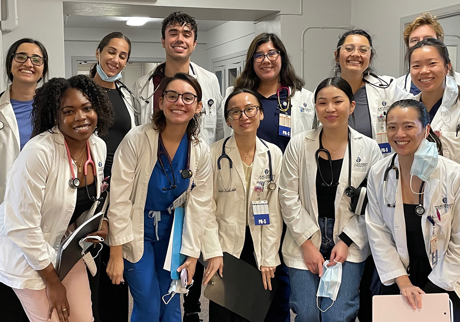 A group of PA students gather together and pose for the camera