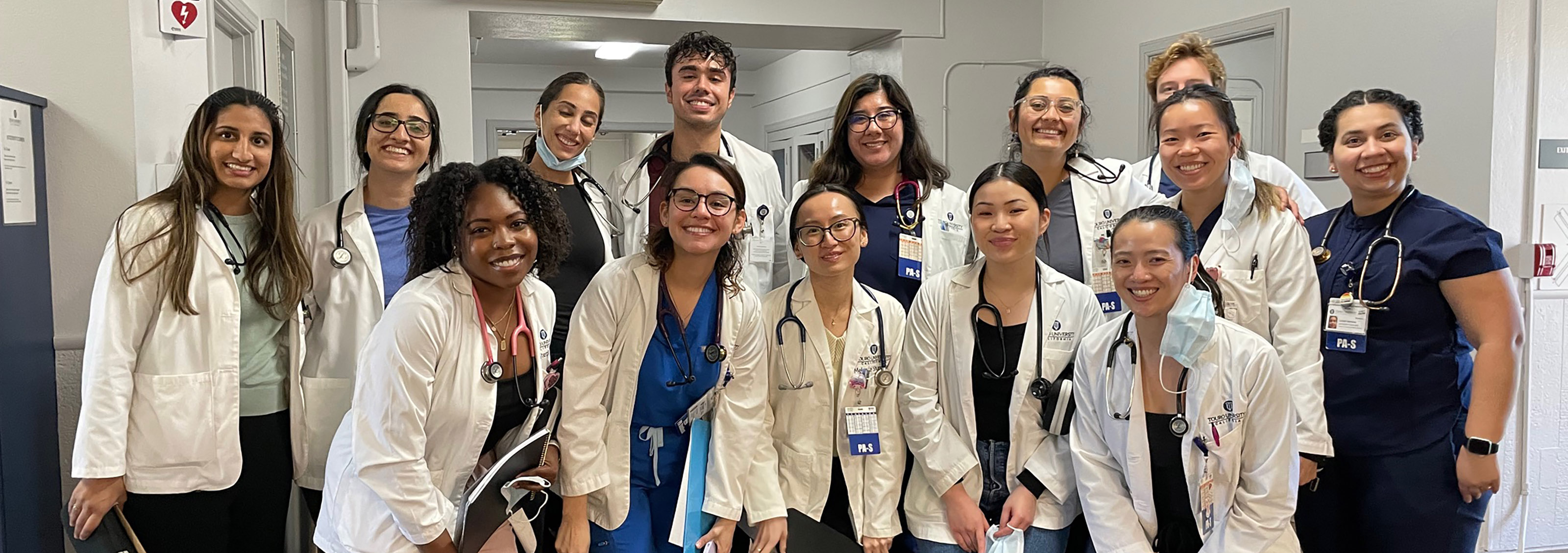 A group of PA students gather together and pose for the camera