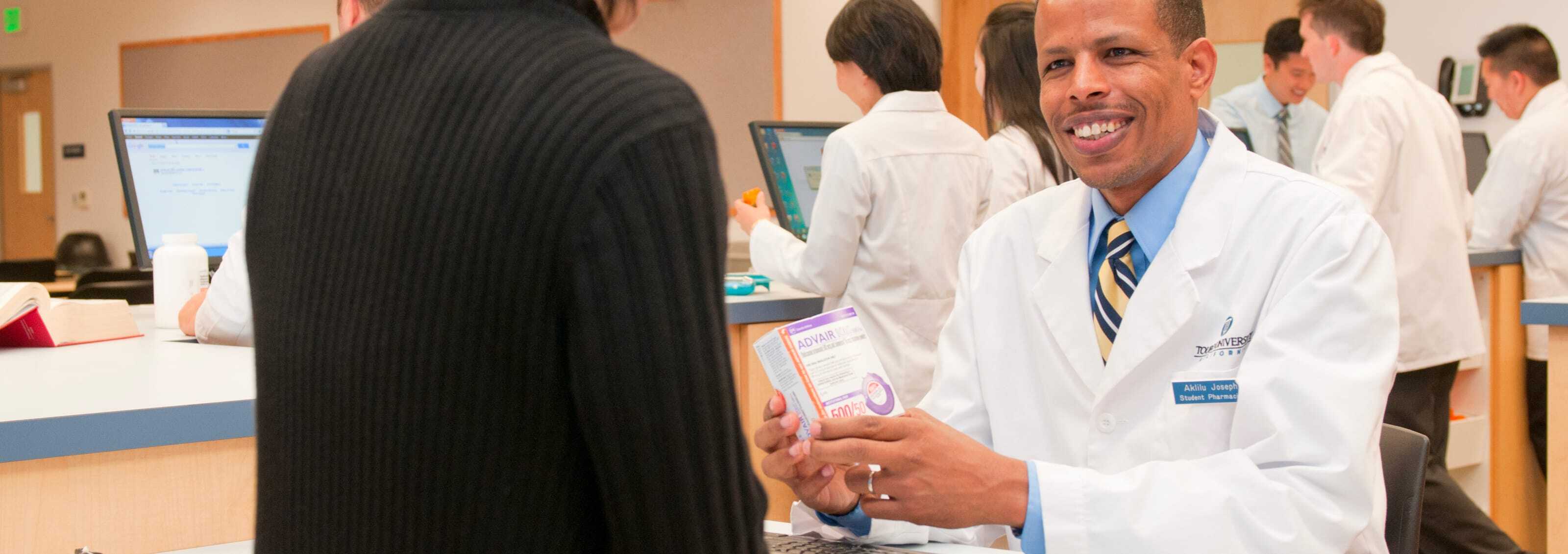 Pharmacy Student talking and smiling with a customer