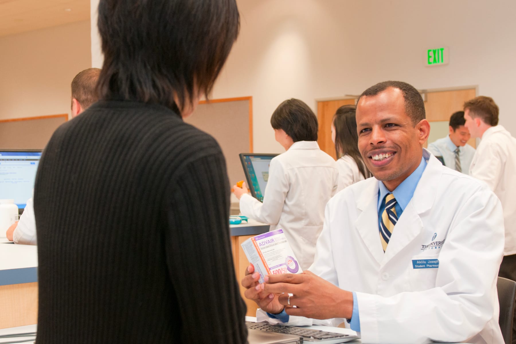 Pharmacy Student talking and smiling with a customer