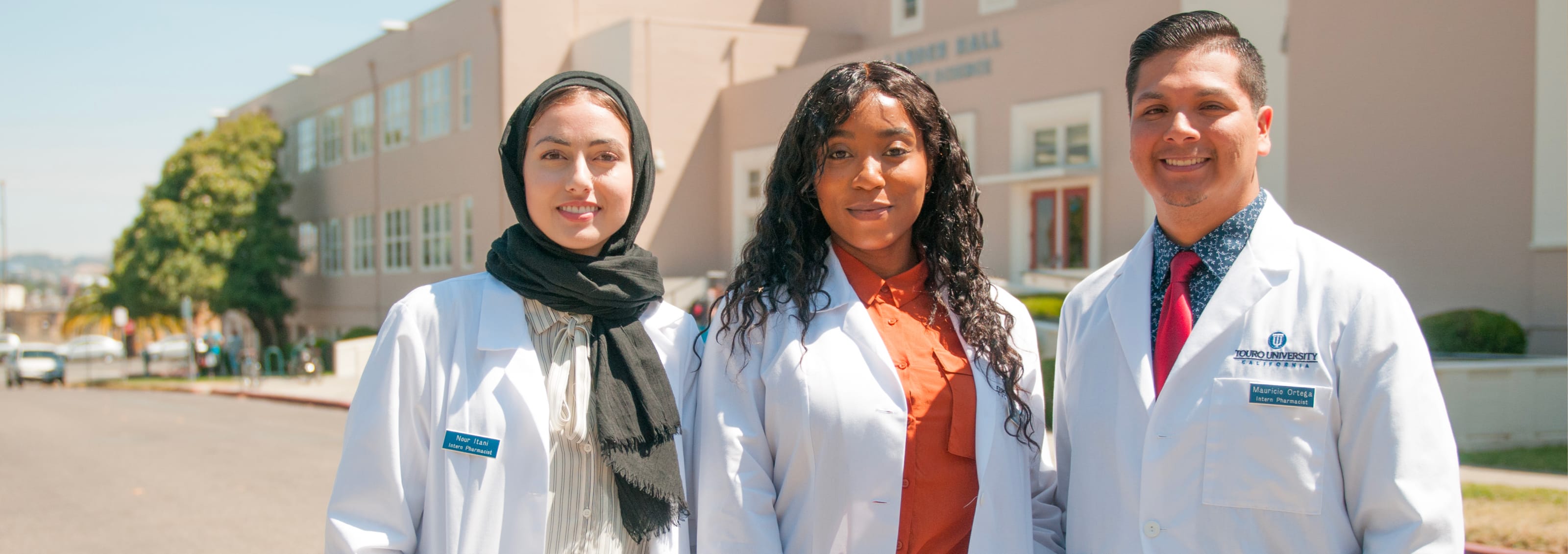 three PharmD students posing outside TUC building