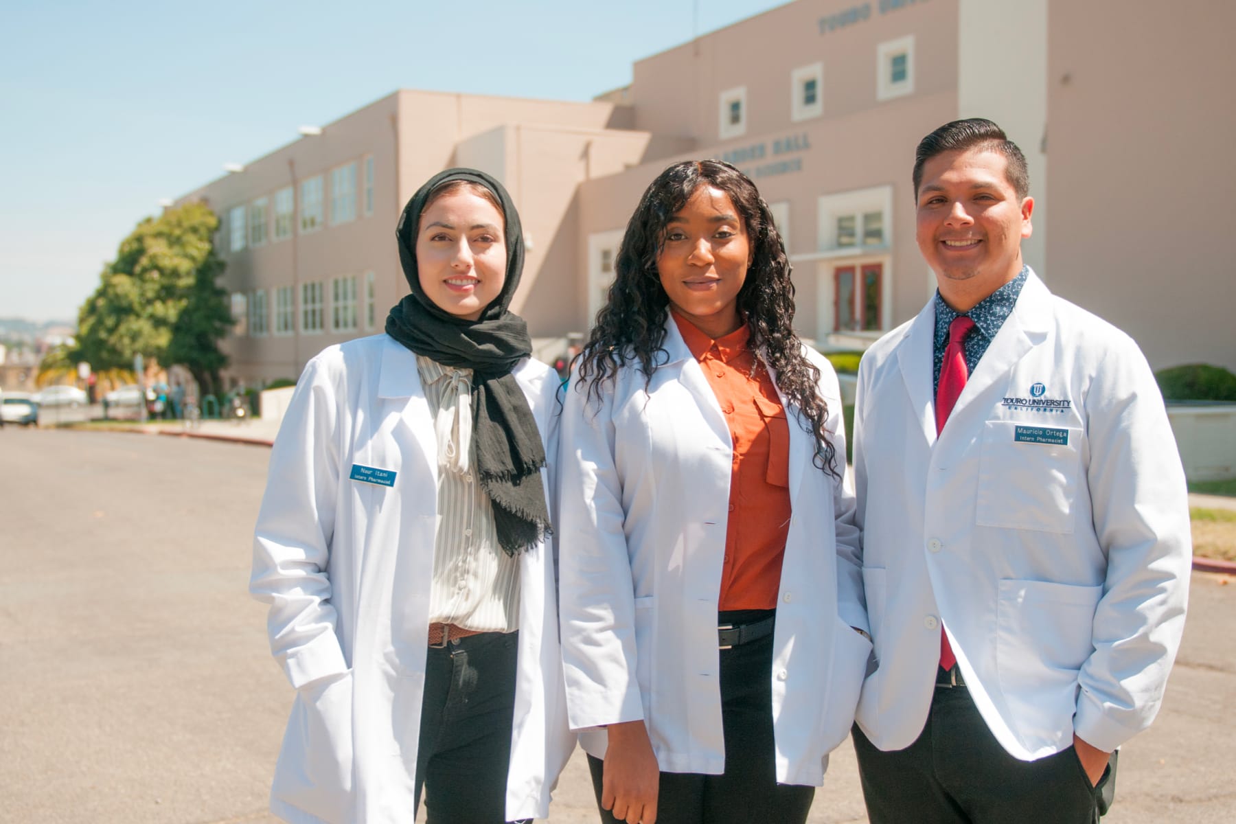 group of pharmacy students posing outside COP building