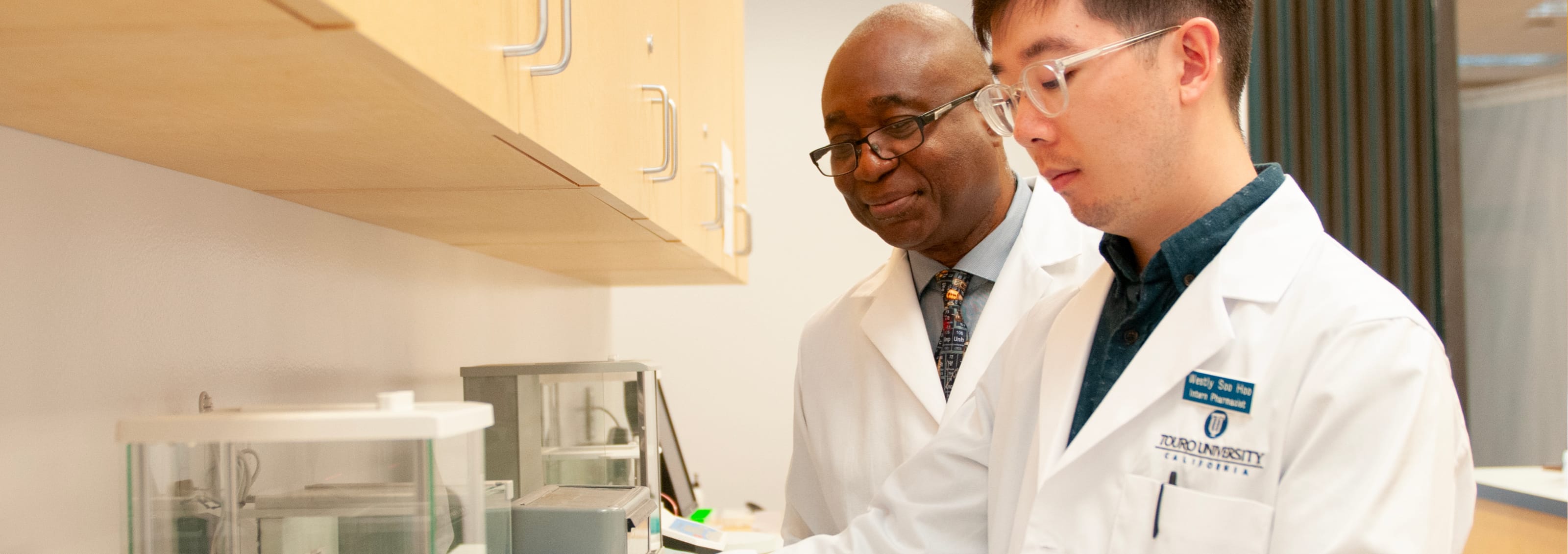 Pharmacy Professor and Pharmacy Student working in a lab