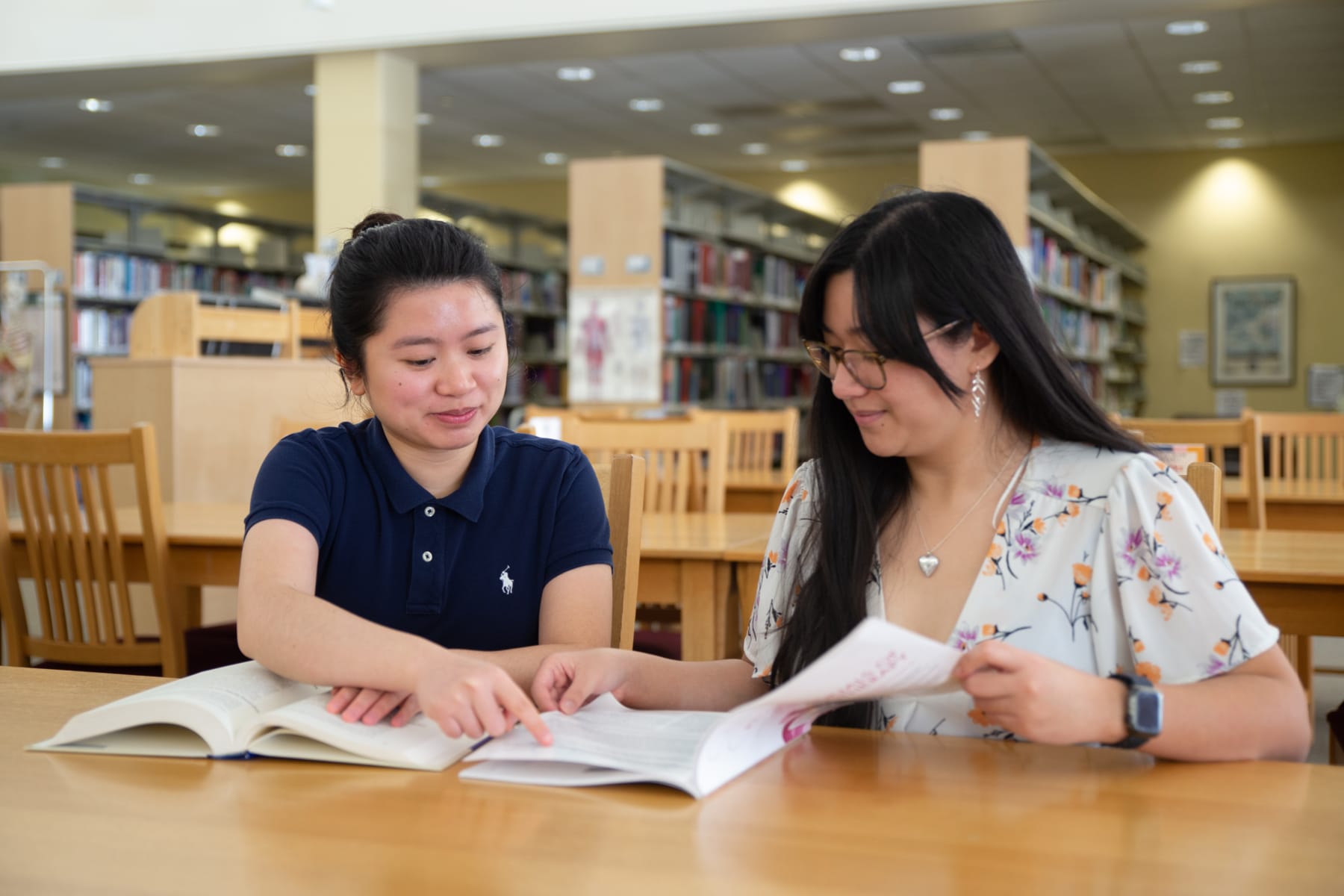 two students working together in library
