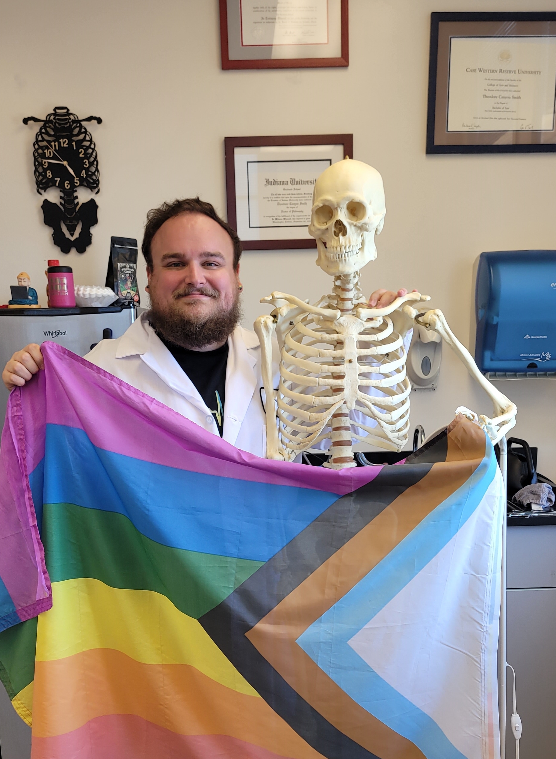 Dr. Theo Smith poses with Skeleton and Flag