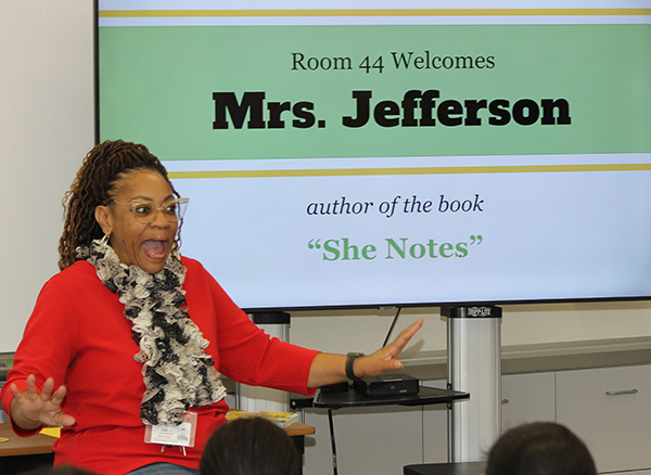 A photo shows Camille Jefferson, vice principal at Hogan Middle School in Vallejo, who gestures as she talks to a class of sixth-graders about the process that led to the publication of her book, "She Notes," Wednesday, Feb. 14, 2024.