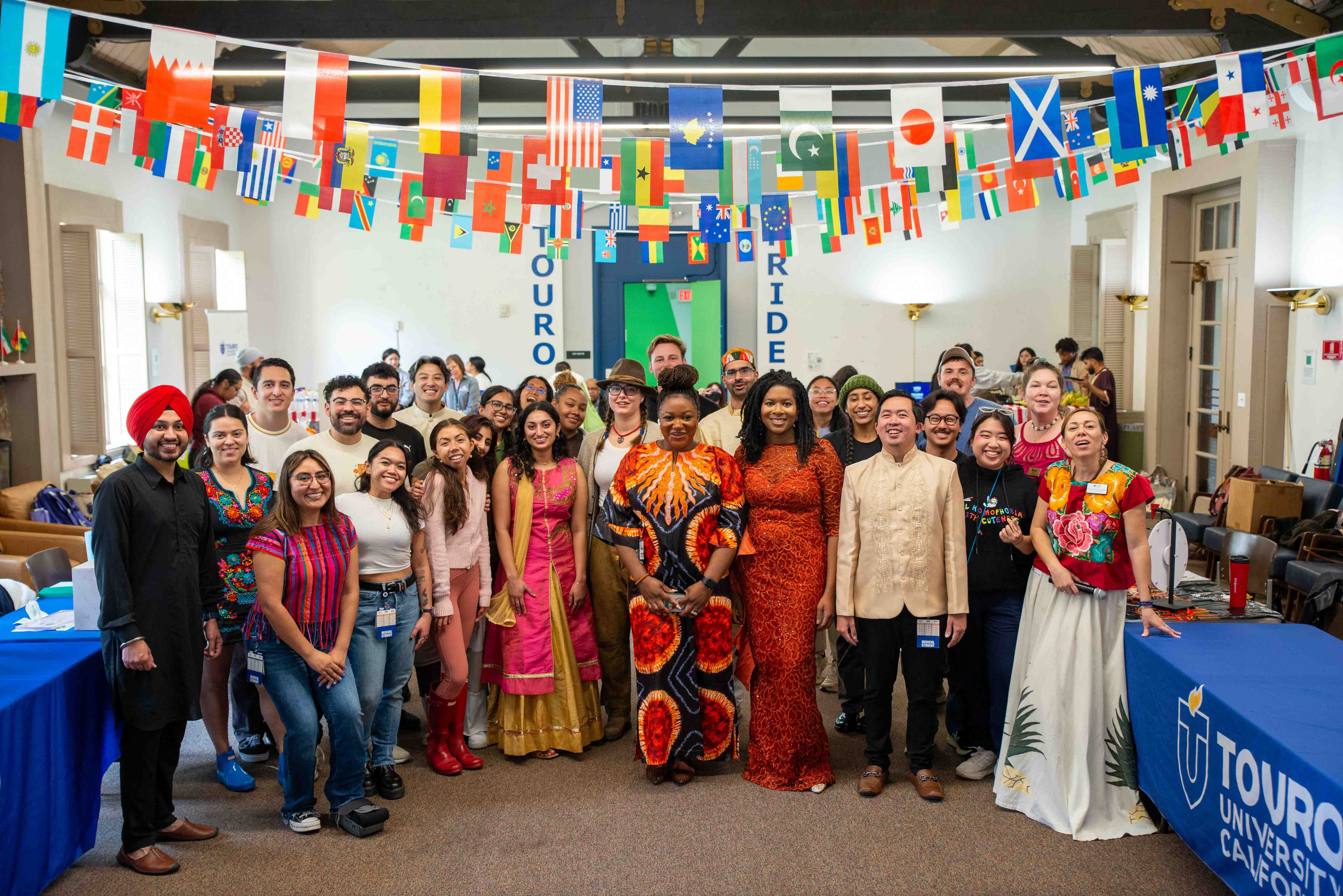 A large group of students gathered in the great room of Wilderman Hall for the Colors of the Community event.