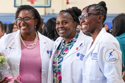 A photo shows Touro University California faculty member Dr. Grace Marie Jones, center, with Student Doctors Kyla Bongay-Williams, left, and Christmead Dorcely, right, during a reception in the Lander Hall gym after Bongay-Williams and Dorcely received their white coats during a ceremony in the Lander Hall Auditorium, Sunday, Aug. 30, 2026.