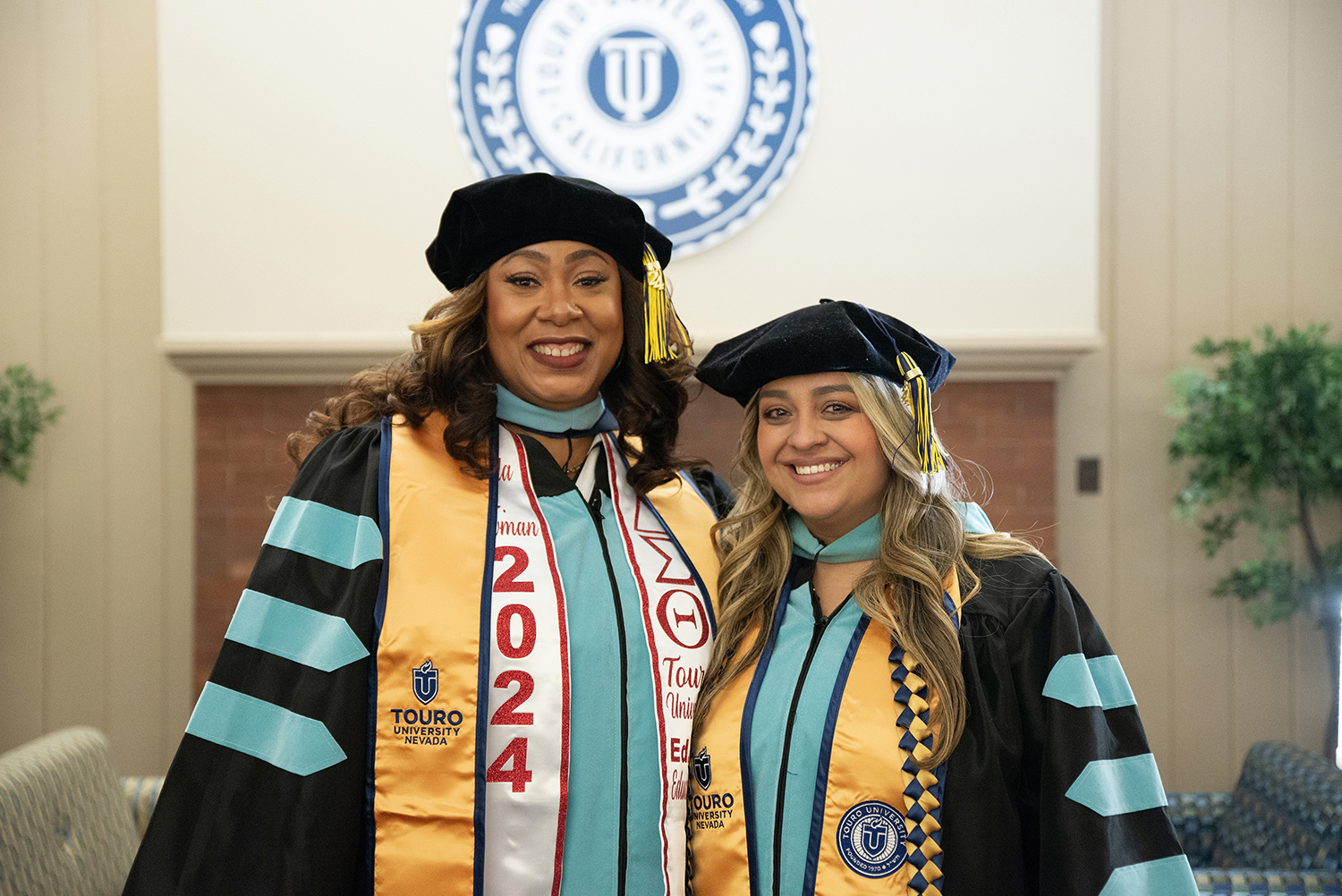 A photo shows Alumnae Shayla Bowman, left, and Cinthia Taylor smiling after being recognized for attaining their Doctor of Education degrees during a ceremony at the Farragut Inn, Dec. 15, 2024. “Touro will always have a special place in my heart,” Bowman said. “I’m so happy I was able to obtain my doctorate from Touro.”