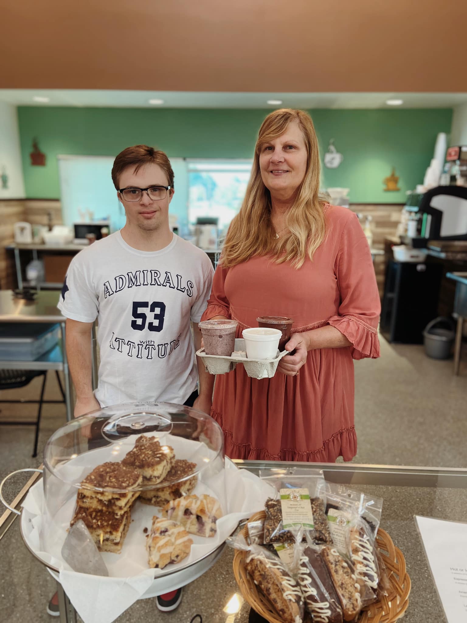 Tristan and Angela Lee pose with coffee and snacks in Riverside Coffee Shop.