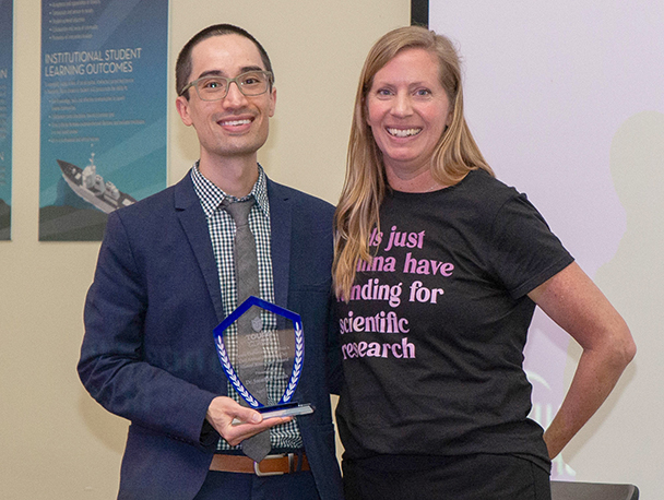 Dr. Jonathan Revels, left, accepts the Alumni Researcher of the Year award from Dr. Carinne Brody. Revels is leading the effort to establish an endowed scholarship for DO students in the College of Osteopathic Medicine at Touro University California. The campaign is called Together We DO.