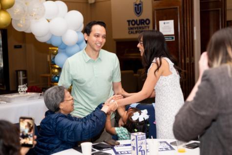 TUCOM student gathers with family after Match Day results.