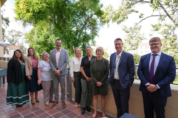 Leadership from Northbay Health and Touro University California pose for a photo on the second floor balcony of Truett Hall on the TUC campus in Vallejo, California.