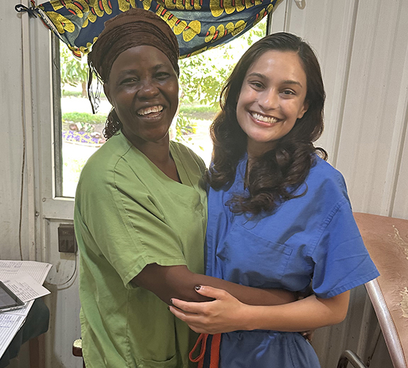A photo shows Samira Hameed, right, as she embraces one of her counterparts, a registered nurse named Rebecca, during Hameed\'s post-MPH Global Health program field study in Chad.