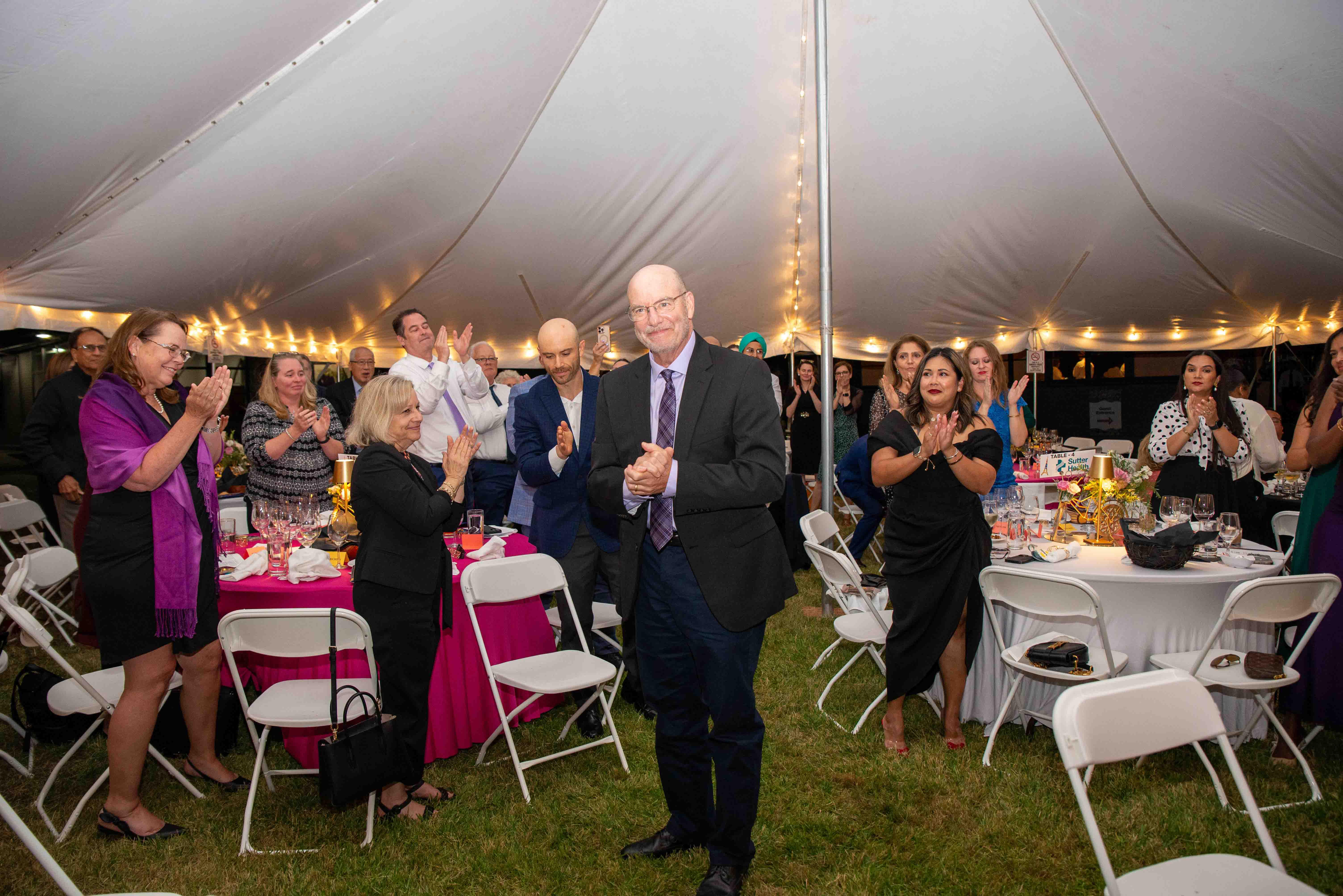 Dr. Richard Riemer and a group of event attendees during the 2025 Mosaic Gala event.