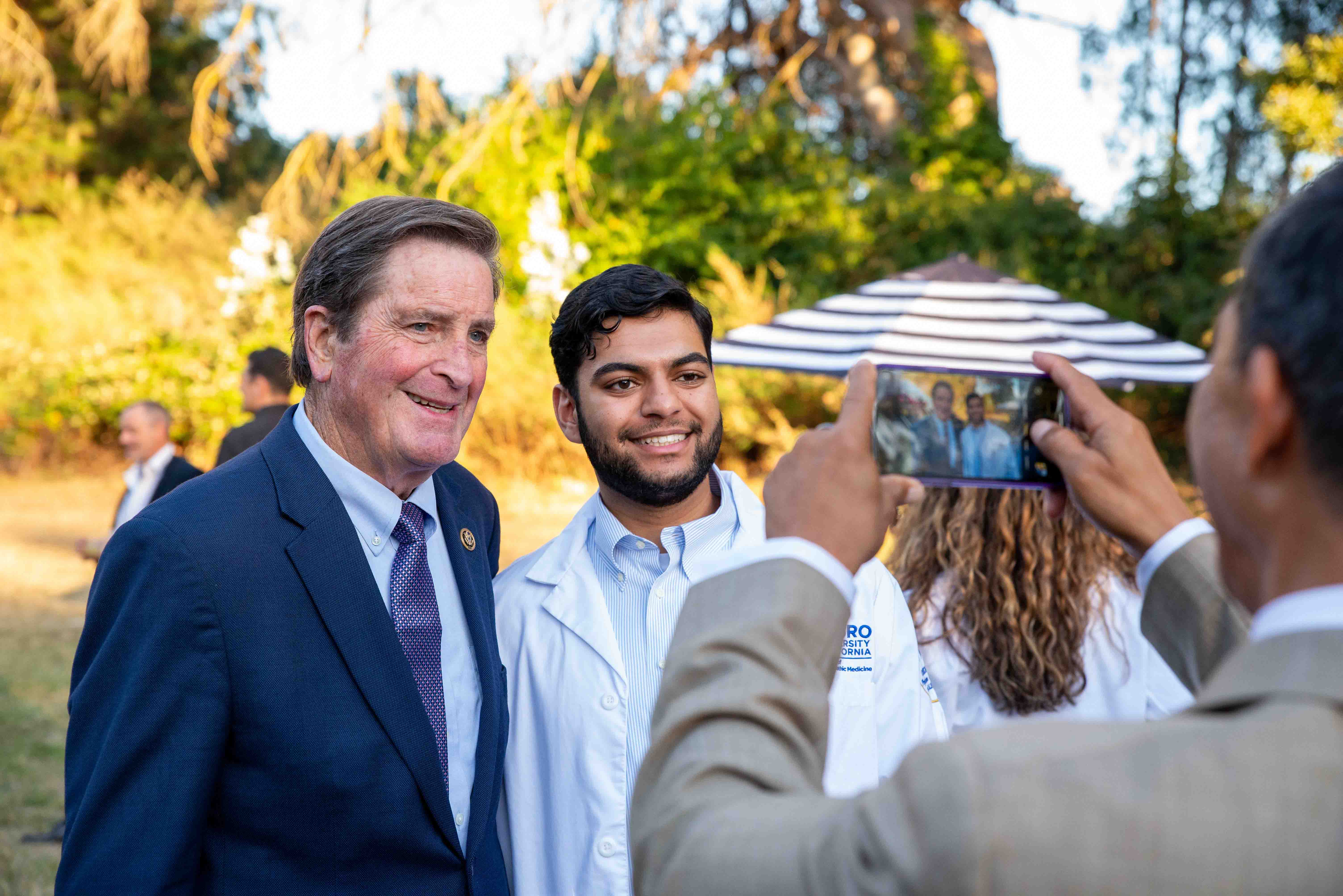 US Congressman John Garamendi with Touro University California College of Osteopathic Medicine student pose for a photo during the 2025 Mosaic Gala.