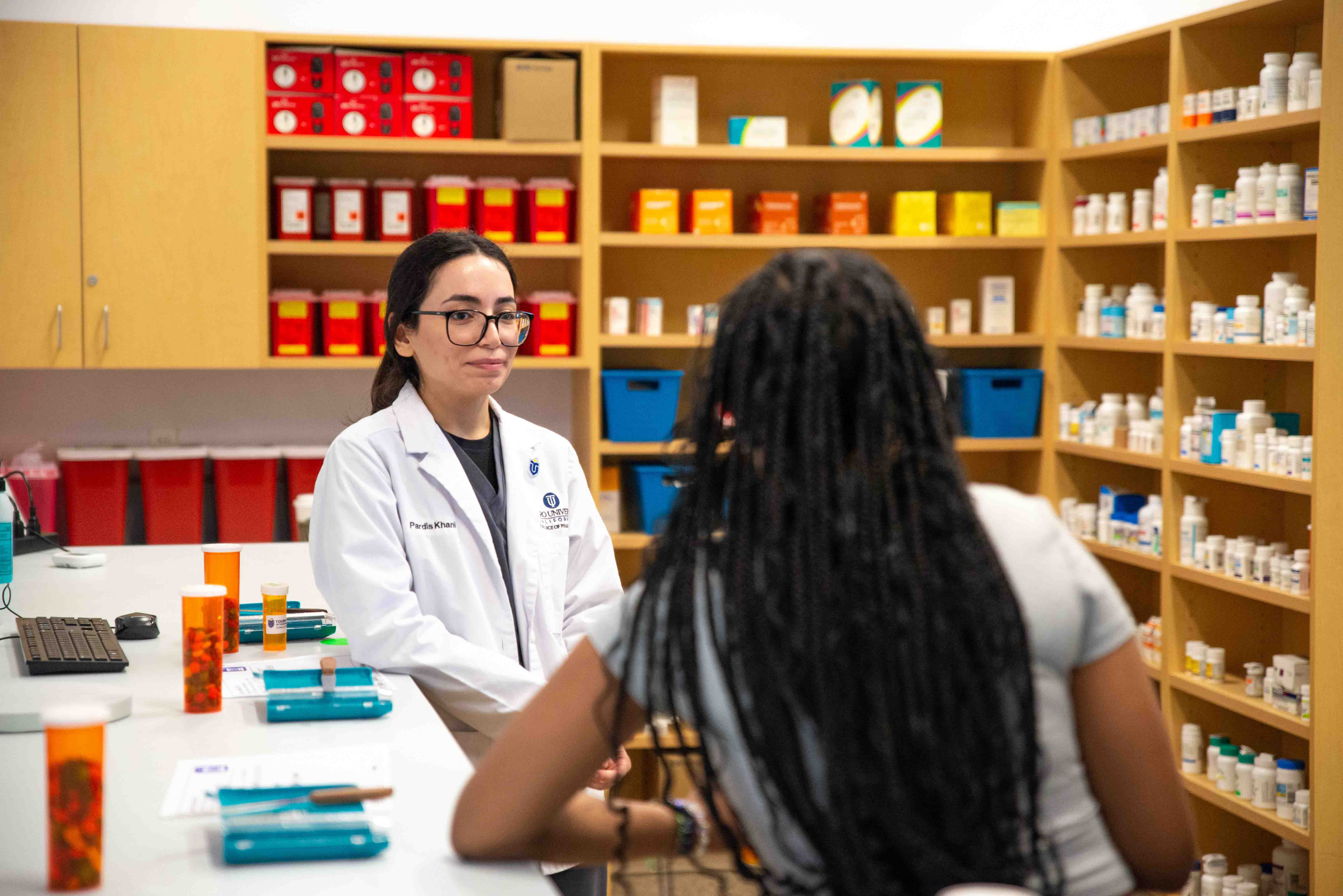 Touro University California College of Pharmacy students speaking with local Solano County high school students.