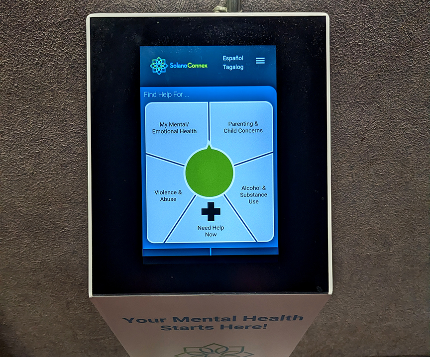 A SolanoConnex mental health kiosk is displayed inside a branch of the Solano library. 
