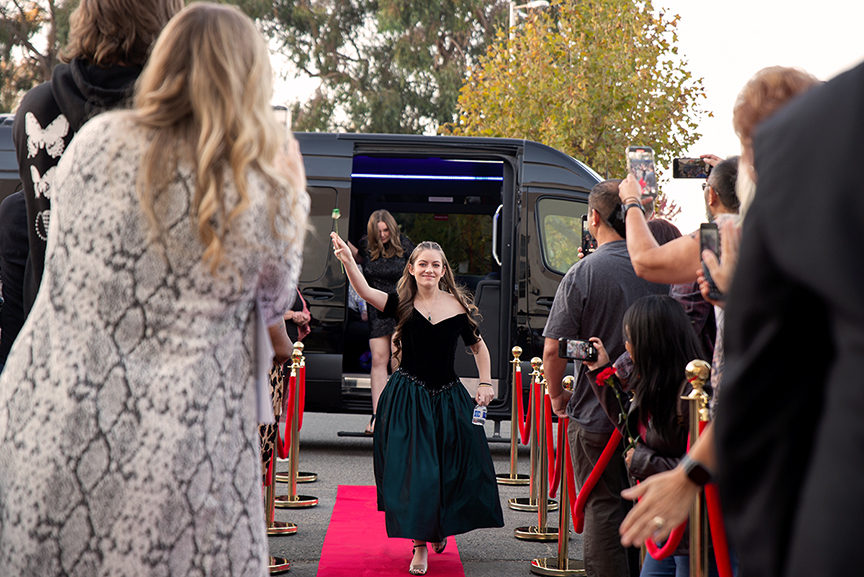 A film student walks down the red carpet during a film premiere event held at Touro University.